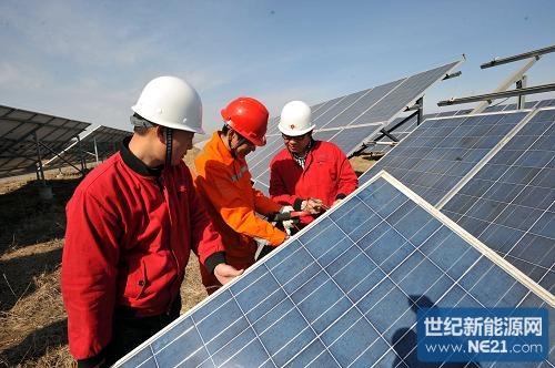 3月10日,国家电网山东德州供电公司技术人员(中)在中节能太阳能发电(德州)有限公司协助检测安装好的电池板。新华社记者范长国摄