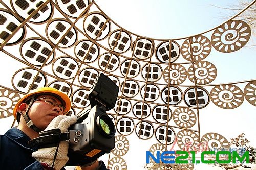 3月6日,山东德州,国家电网工作人员在观察太阳能光电雕塑运行状况。(梁宝海 摄)